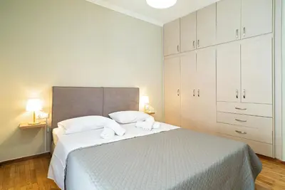 a bedroom with a bed with two towels on it at Filoxenia MG Projects Acropolis Dimitrakopulou in Athens