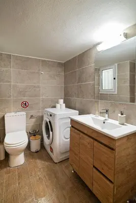 a bathroom with a toilet sink and a washing machine at Filoxenia MG Projects Acropolis Dimitrakopulou in Athens