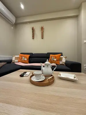 a living room with a table with a tea pot on it at Filoxenia MG Projects Acropolis Dimitrakopulou in Athens