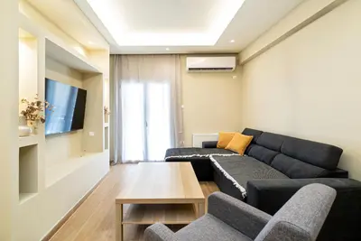 a living room with a couch and a table at Filoxenia MG Projects Acropolis Dimitrakopulou in Athens