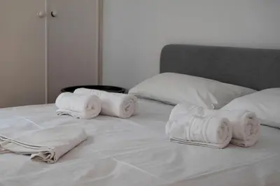 a bed with white towels on top of it at Thissio Getaway 2BA next to Athens ancient market in Athens