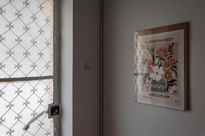 a picture hanging on a wall next to a window at Thissio Getaway 2BA next to Athens ancient market in Athens
