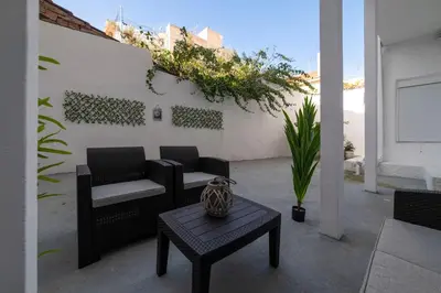a patio with two chairs and a coffee table at Thissio Getaway 2BA next to Athens ancient market in Athens