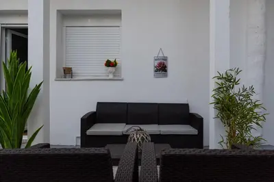 a patio with a couch and a table and chairs at Thissio Getaway 2BA next to Athens ancient market in Athens