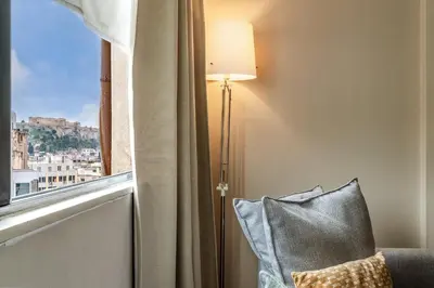 a lamp sitting next to a window with a pillow at Central Athens Loft C in Athens
