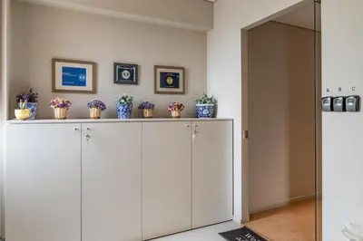 a living room with white cabinets and potted plants at Central Athens Loft C in Athens
