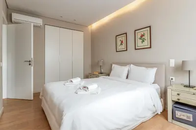 a bedroom with a large white bed with two towels on it at Central Athens Loft C in Athens