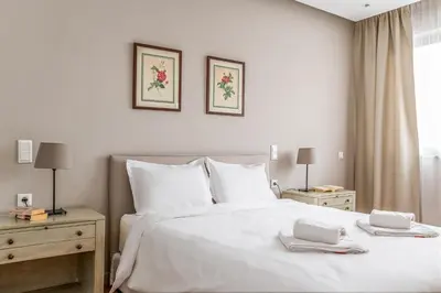a bedroom with a white bed with two towels on it at Central Athens Loft C in Athens