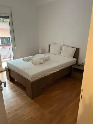a bedroom with a large bed with white sheets and pillows at Delightful 2BR Apt in the Heart of Kypseli! in Athens