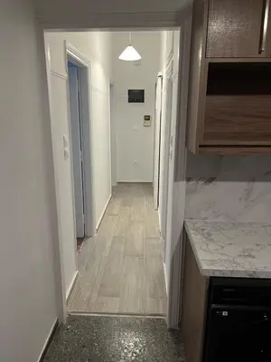 an empty hallway with a hallway leading to a kitchen at Delightful 2BR Apt in the Heart of Kypseli! in Athens