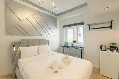 a bedroom with a large white bed with white pillows at Diamond Tsakalof 17 by Zeussuites in Athens