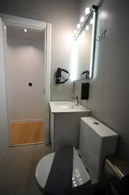 a bathroom with a toilet and a sink and a mirror at Diamond Tsakalof 17 by Zeussuites in Athens