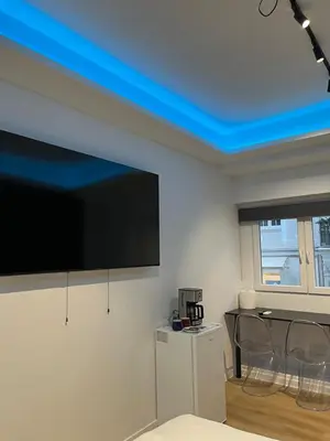 a living room with a blue ceiling at Platinum Jacuzzi Tsakalof 17 by Zeussuites in Athens