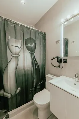 a bathroom with a toilet and a shower curtain at Platinum Jacuzzi Tsakalof 17 by Zeussuites in Athens