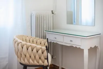 a white desk with a chair and a mirror at Athens city gem in koukaki in Athens