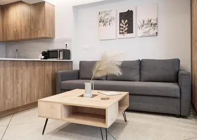 a living room with a couch and a coffee table at Bright space with street view, near Acropolis in Athens