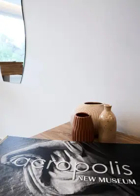 a table with a book and a vase on it at Bright space with street view, near Acropolis in Athens