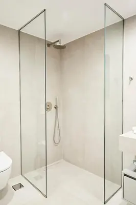 a glass shower in a bathroom with a toilet at Bright space with street view, near Acropolis in Athens