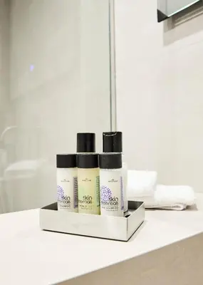 two products sitting on a counter in front of a mirror at Bright space with street view, near Acropolis in Athens