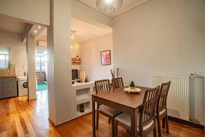 a kitchen and dining room with a table and chairs at The Condo Spacious terrace Acropolis Views in Athens