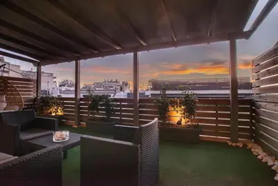 a balcony with chairs and a table with a view of the city at The Condo Spacious terrace Acropolis Views in Athens