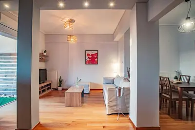 a living room with a table and a dining room at The Condo Spacious terrace Acropolis Views in Athens