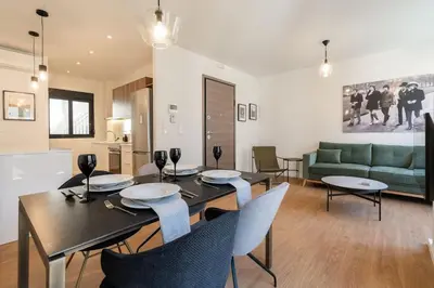 a dining room and living room with a table and chairs at Kypseli Elegant Living in Athens