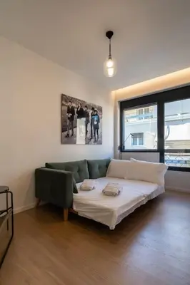 a living room with a bed and a couch at Kypseli Elegant Living in Athens