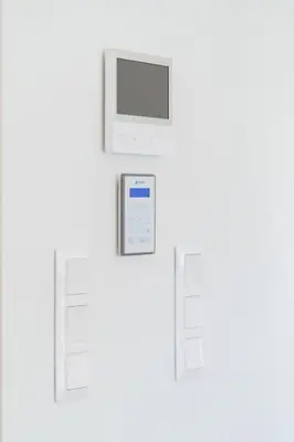 an electronic device with a monitor on a white wall at Kypseli Elegant Living in Athens