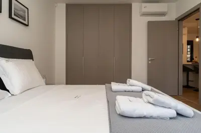 a bedroom with a bed with white towels on it at Kypseli Elegant Living in Athens