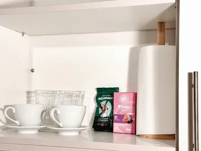 a shelf with two cups and a bag of coffee at Cozy Aparthotel Pangrati in Athens