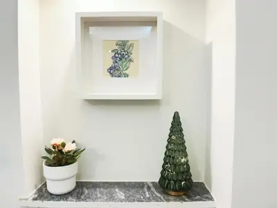 a christmas tree sitting on a shelf next to a plant at Cozy Aparthotel Pangrati in Athens