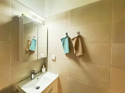 a bathroom with a sink and a mirror at Cozy Aparthotel Pangrati in Athens