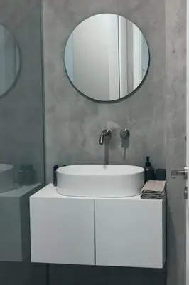a bathroom with a white sink and a mirror at Urban-chic apartment in the heart of Athens in Athens