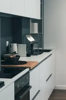 a kitchen with a wooden cutting board on a counter at Urban-chic apartment in the heart of Athens in Athens