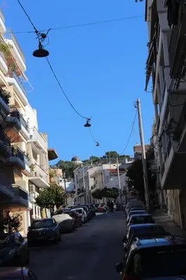 a street with cars parked on the side of the road at Urban-chic apartment in the heart of Athens in Athens