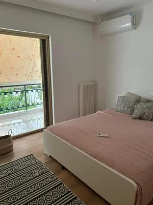 a bedroom with a large bed and a large window at Zen Alimos in Athens