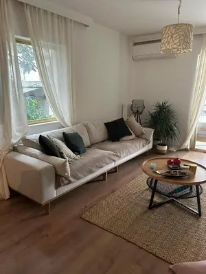 a living room with a couch and a table at Zen Alimos in Athens
