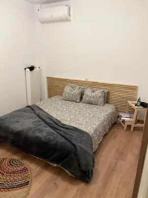 a bedroom with a bed and a wooden floor at Zen Alimos in Athens