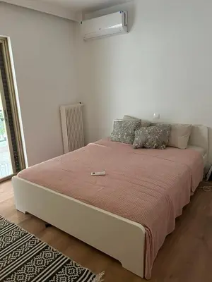 a large bed in a white room with at Zen Alimos in Athens