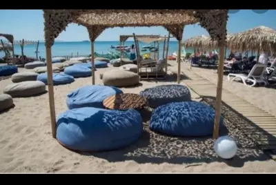 a row of blue bean bags on the beach at Zen Alimos in Athens