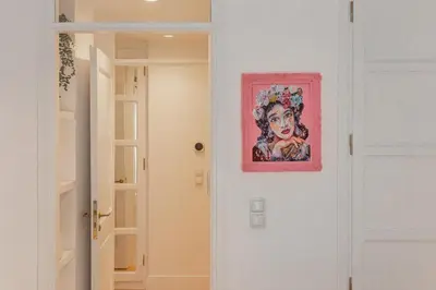 a painting of a woman on a wall next to a door at Timeless Athens Cozy Apartment in Athens