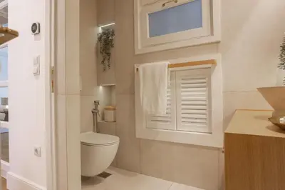 a bathroom with a toilet and a window at Timeless Athens Cozy Apartment in Athens