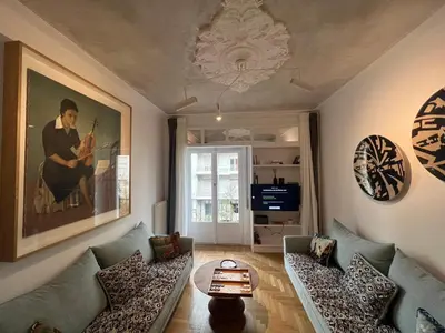 a living room with two couches and a painting at Timeless Athens Cozy Apartment in Athens