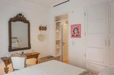 a bedroom with a bed and a mirror and a table at Timeless Athens Cozy Apartment in Athens