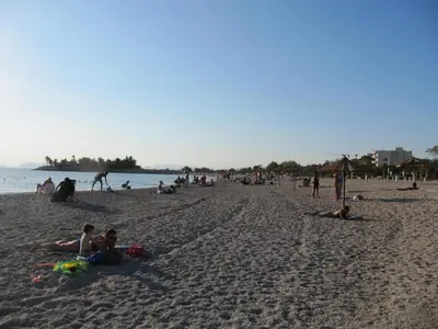 a group of people laying on a beach at Cosy Studio at the heart of glyfada in Athens