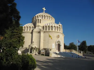 a church with a cross on top of a building at Cosy Studio at the heart of glyfada in Athens