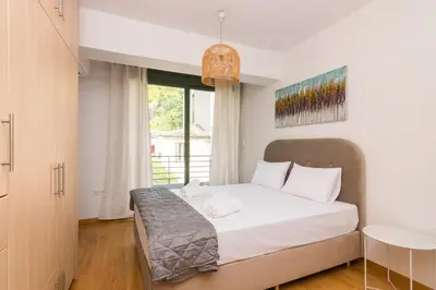 a bedroom with a bed and a large window at Ideal Maisonette next to Kallimarmaro Stadium in Athens