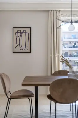 a dining room with a wooden table and chairs at Comfortable 3BR Family Residence in Agia Paraskevi by UPSTREET in Athens