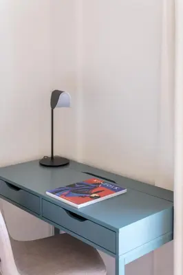 a blue desk with a lamp and a book on it at Comfortable 3BR Family Residence in Agia Paraskevi by UPSTREET in Athens